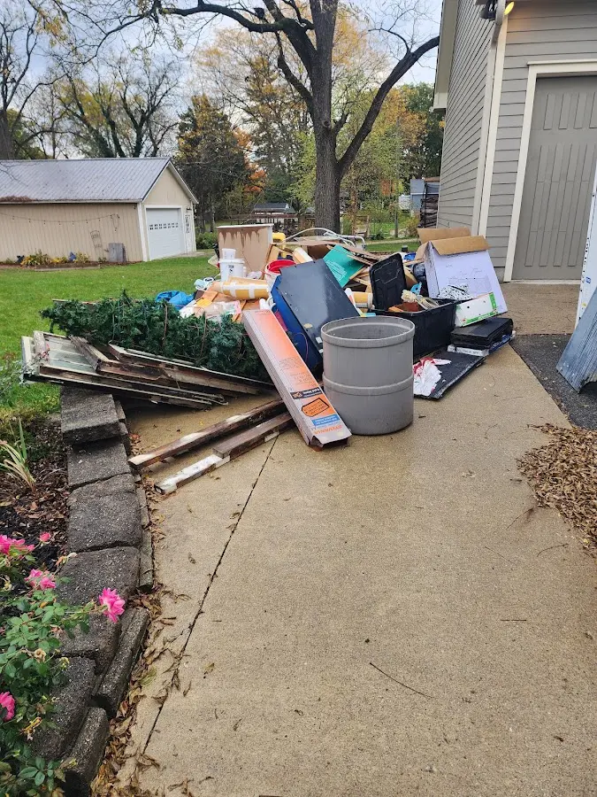 Dumpster being loaded with debris for 12 Yard Dumpster Rental in Brunswick